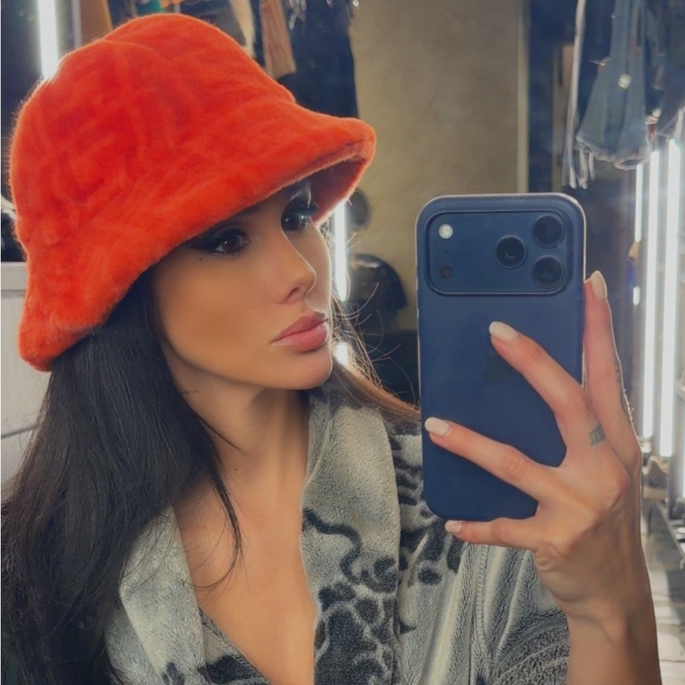 Fendi shearling bucket hat with a Zucca monogram pattern.Orange/Red Fuzzy